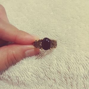Ring With Black Stone And Flowers On The Side.